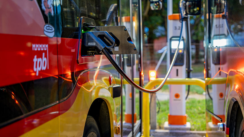 Elektrobus lädt an einer Ladestation; mehrere Ladepunkte stehen nebeneinander.